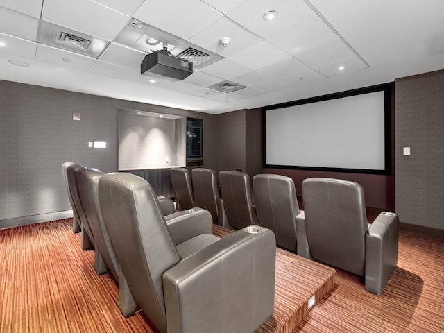 home theater room featuring a drop ceiling and hardwood / wood-style flooring