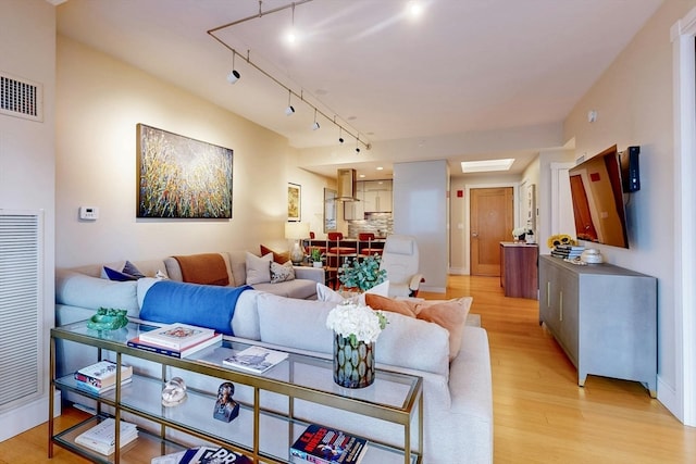 living room featuring light hardwood / wood-style flooring and track lighting