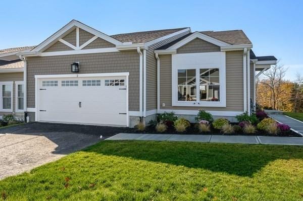 view of front of property featuring a front yard and a garage