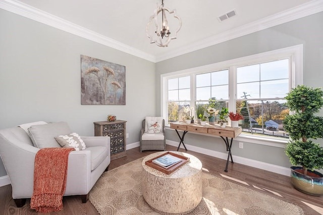 sitting room featuring ornamental molding, plenty of natural light, dark wood-type flooring, and an inviting chandelier