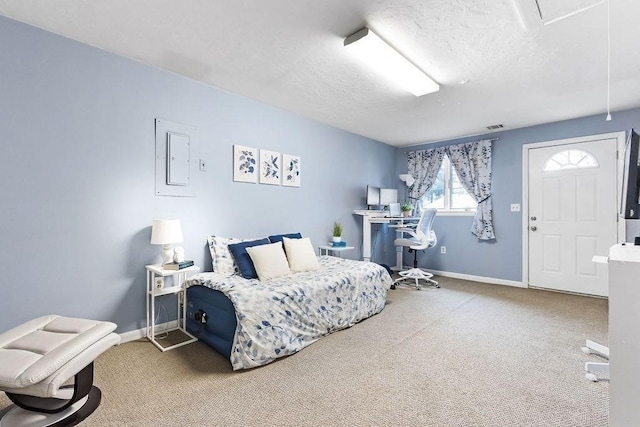 carpeted bedroom with visible vents, a textured ceiling, and baseboards