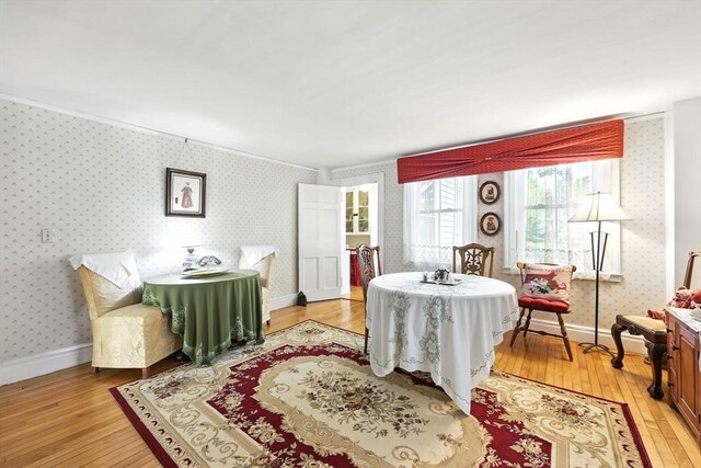 96 College St, South Hadley, MA 01075 - dining area featuring light wood-type flooring, wallpapered walls, and baseboards