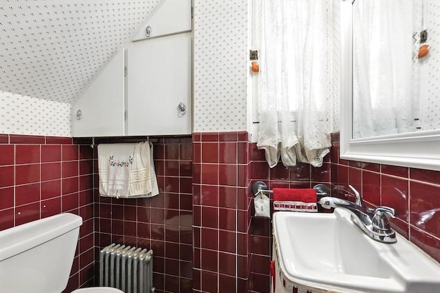 96 College St, South Hadley, MA 01075 - bathroom featuring radiator heating unit, a sink, tile walls, and toilet