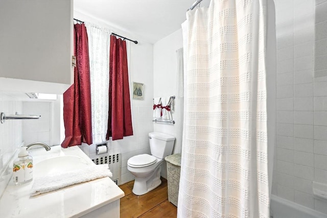 96 College St, South Hadley, MA 01075 - full bath featuring radiator heating unit, toilet, vanity, wood finished floors, and shower / bath combo with shower curtain