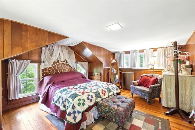 96 College St, South Hadley, MA 01075 - bedroom with radiator heating unit, multiple windows, hardwood / wood-style floors, and wooden walls