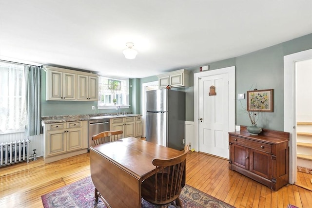 96 College St, South Hadley, MA 01075 - kitchen featuring cream cabinets, appliances with stainless steel finishes, and light wood-style flooring