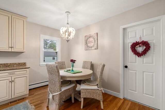 137 Pond, Westwood, MA 02090 - dining area with a chandelier, light wood-type flooring, a baseboard radiator, and baseboards