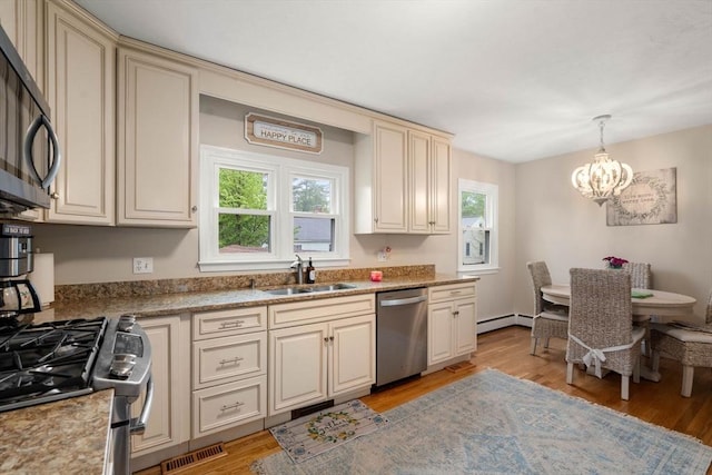 137 Pond, Westwood, MA 02090 - kitchen with appliances with stainless steel finishes, cream cabinets, and healthy amount of natural light