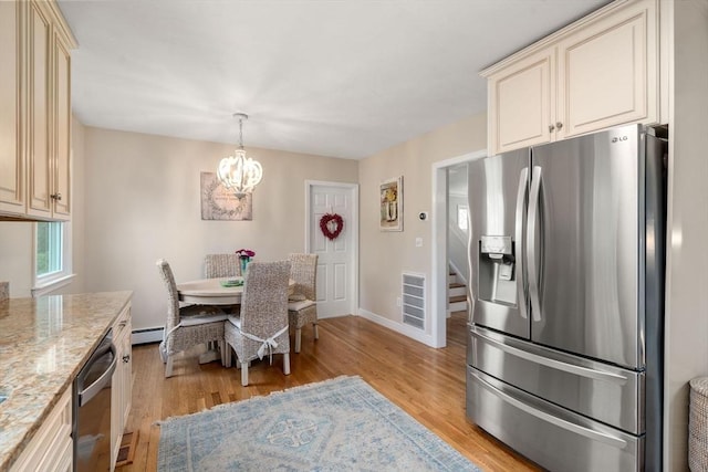 137 Pond, Westwood, MA 02090 - kitchen featuring stainless steel fridge, cream cabinetry, dishwashing machine, and a chandelier