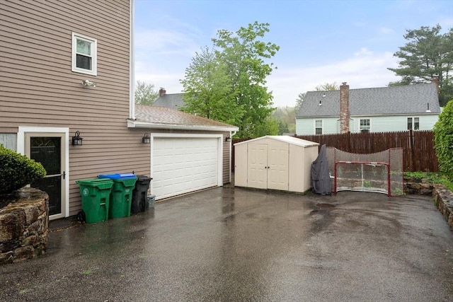 137 Pond, Westwood, MA 02090 - garage with a storage unit, driveway, and fence