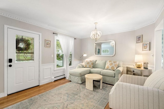 137 Pond, Westwood, MA 02090 - living area featuring wood finished floors, a baseboard radiator, a chandelier, a wainscoted wall, and ornamental molding