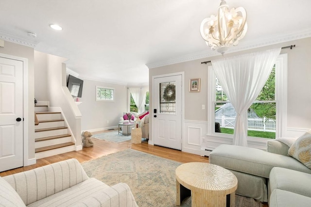 137 Pond, Westwood, MA 02090 - living area featuring a chandelier, stairway, healthy amount of natural light, wood finished floors, and crown molding