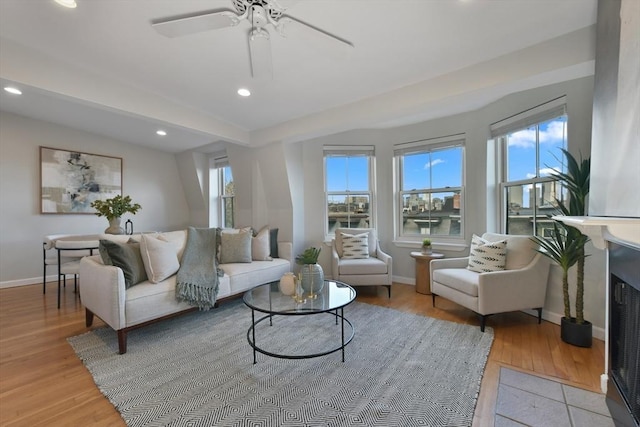 living room with lofted ceiling, plenty of natural light, and light hardwood / wood-style flooring