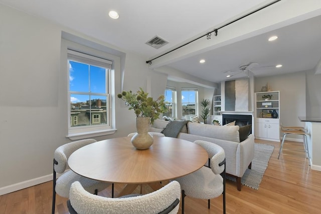 dining space featuring light hardwood / wood-style floors and ceiling fan