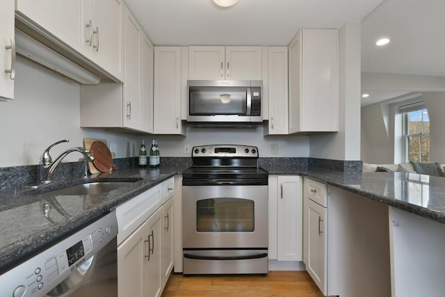 kitchen with stainless steel appliances and white cabinetry