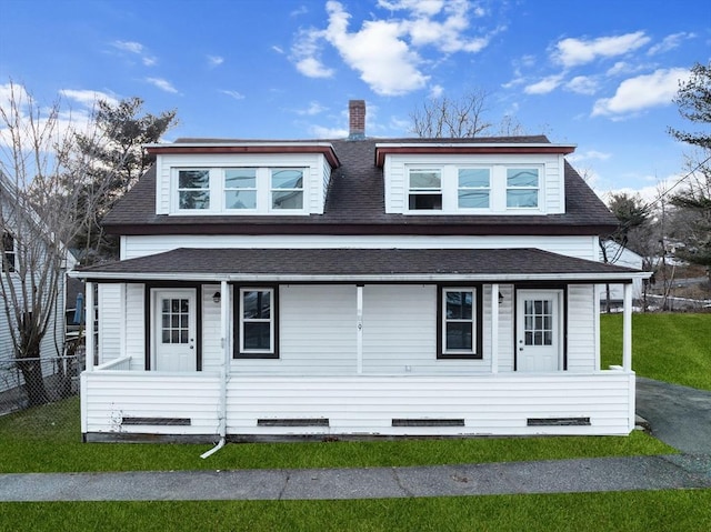 view of front of house with covered porch and a front yard