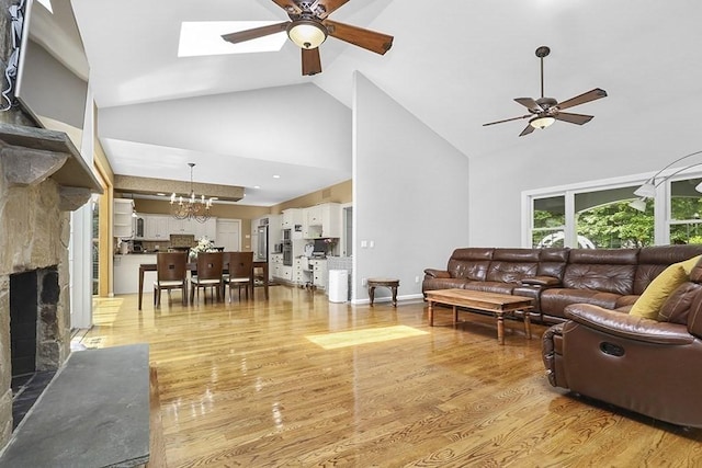 18 Village Hill Rd, Dover, MA 02030 - living room with a ceiling fan, high vaulted ceiling, a stone fireplace, light wood finished floors, and a chandelier