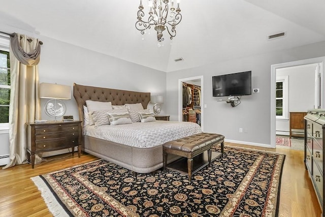 18 Village Hill Rd, Dover, MA 02030 - bedroom featuring lofted ceiling, light wood-style floors, a spacious closet, a chandelier, and baseboards