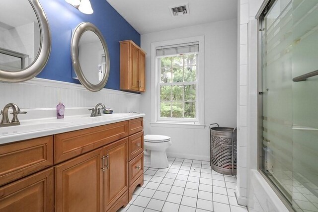 18 Village Hill Rd, Dover, MA 02030 - full bath with double vanity, tile patterned flooring, toilet, a wainscoted wall, and enclosed tub / shower combo