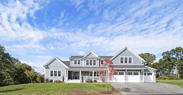 5 Bullens Way, Canton, MA 02021 - view of front of property featuring covered porch, asphalt driveway, a front lawn, a garage, and roof with shingles