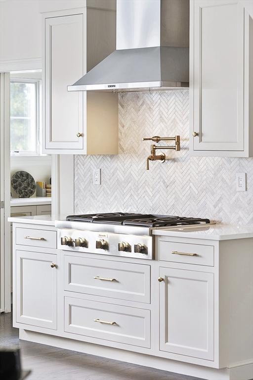 5 Bullens Way, Canton, MA 02021 - kitchen featuring wall chimney exhaust hood, stainless steel gas stovetop, light countertops, and backsplash