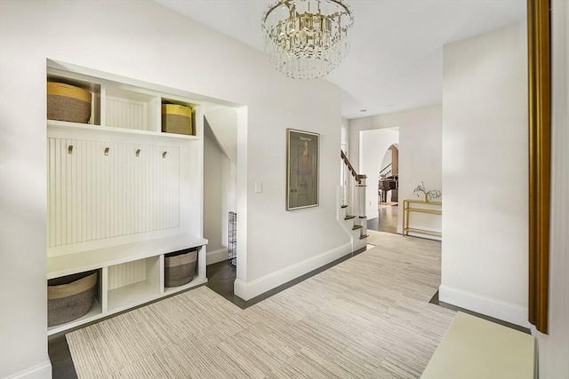 5 Bullens Way, Canton, MA 02021 - mudroom featuring arched walkways, baseboards, a chandelier, and wood finished floors