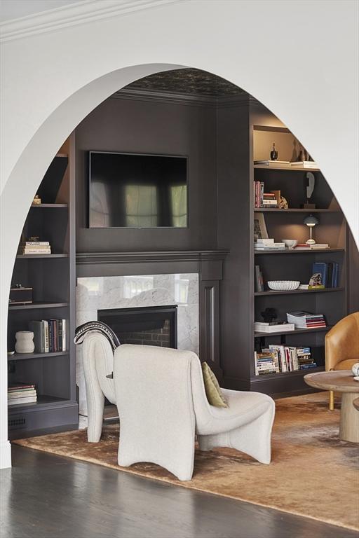 5 Bullens Way, Canton, MA 02021 - sitting room featuring built in shelves, ornamental molding, wood finished floors, a premium fireplace, and arched walkways