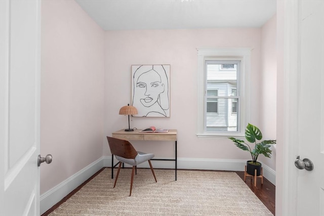 office space featuring baseboards and wood finished floors