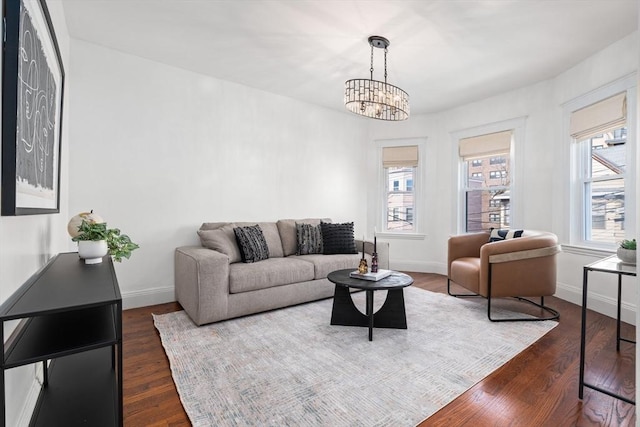 living area with dark wood finished floors, a healthy amount of sunlight, and baseboards