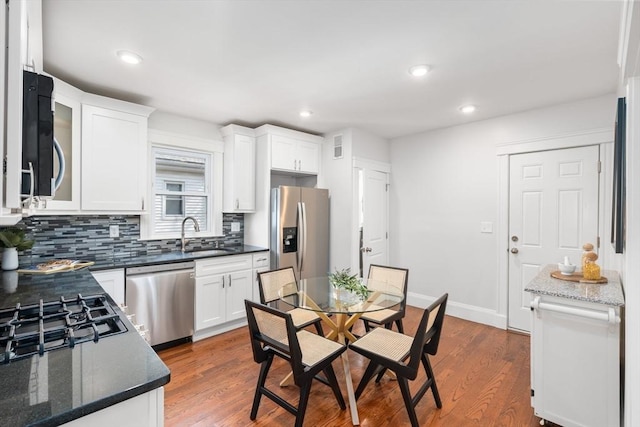 kitchen with white cabinetry, dark wood-style flooring, and stainless steel appliances