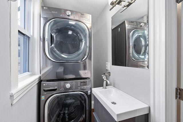 laundry room featuring a sink, laundry area, and stacked washing maching and dryer