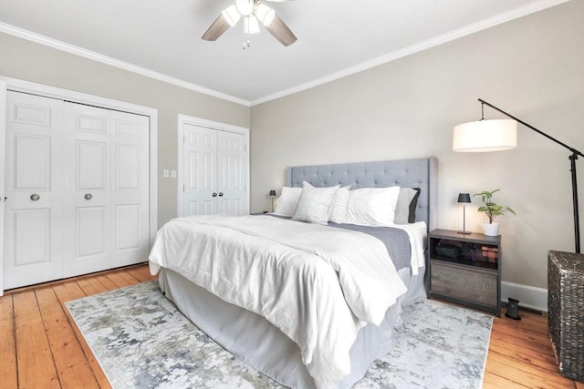 356 Bunker Hill St Unit 2, Boston, MA 02129 - bedroom with two closets, hardwood / wood-style flooring, ornamental molding, ceiling fan, and baseboards