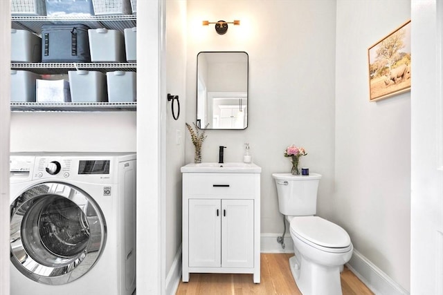 356 Bunker Hill St Unit 2, Boston, MA 02129 - laundry area with washer / dryer, light wood-type flooring, a sink, and baseboards