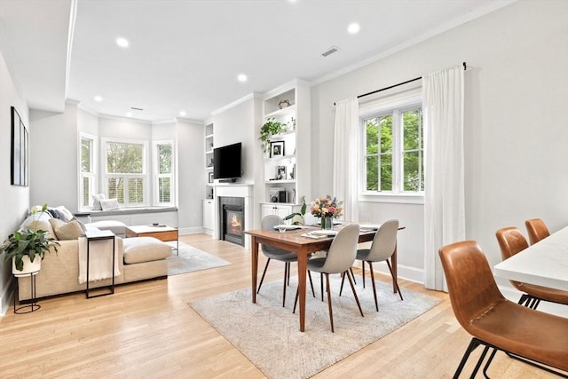 356 Bunker Hill St Unit 2, Boston, MA 02129 - dining area with a glass covered fireplace, recessed lighting, light wood-style floors, crown molding, and baseboards