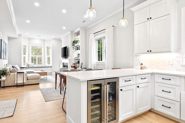356 Bunker Hill St Unit 2, Boston, MA 02129 - kitchen with beverage cooler, open floor plan, plenty of natural light, crown molding, and light countertops