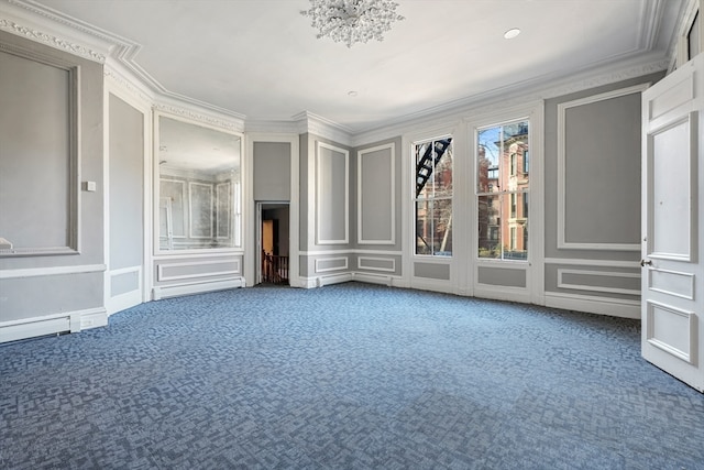 interior space with dark carpet, ornamental molding, a baseboard heating unit, and a chandelier