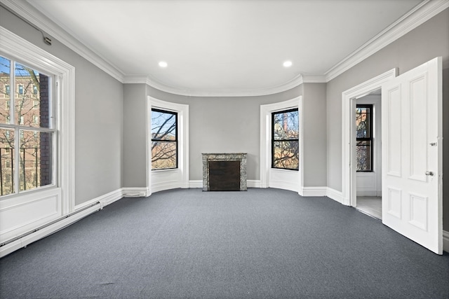 interior space with baseboard heating, ornamental molding, and plenty of natural light