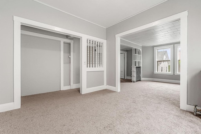 unfurnished living room with carpet and crown molding