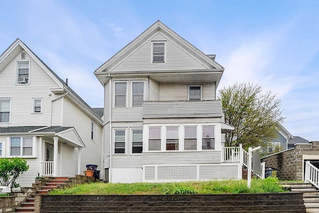 view of front of home featuring stairway