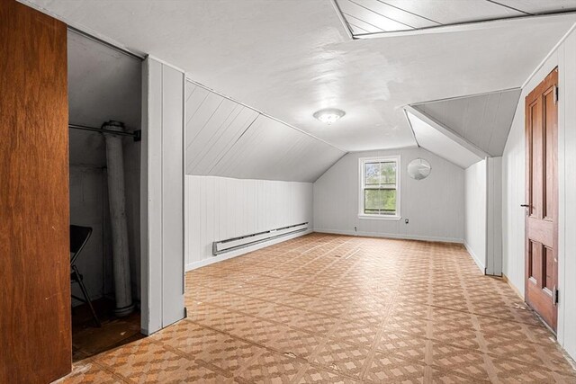 bonus room with a baseboard radiator, lofted ceiling, and baseboards