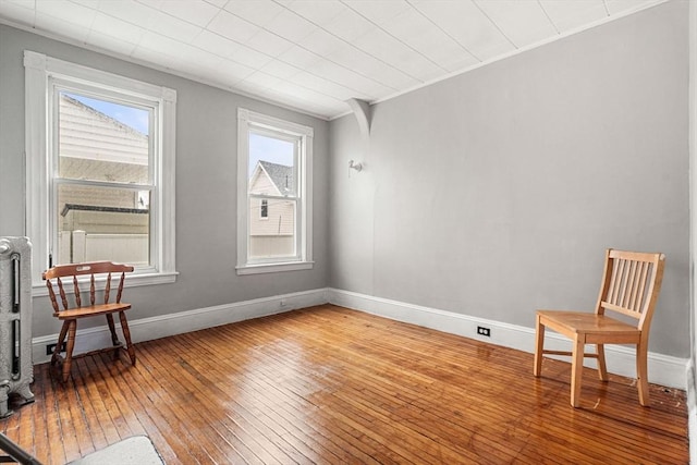 unfurnished room featuring light wood finished floors and baseboards