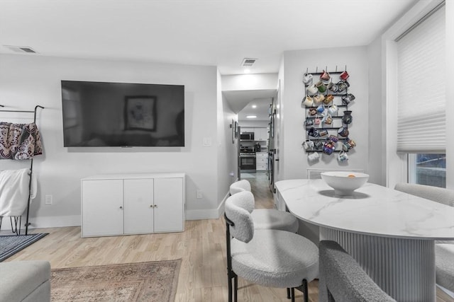 dining space featuring light hardwood / wood-style flooring