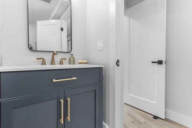 bathroom featuring vanity and hardwood / wood-style floors