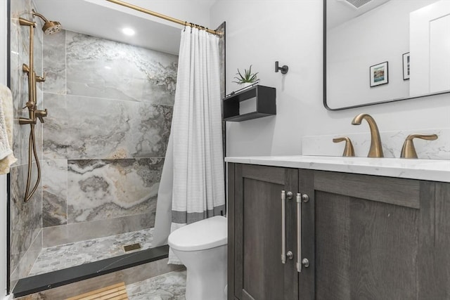 bathroom featuring vanity, toilet, and a shower with shower curtain