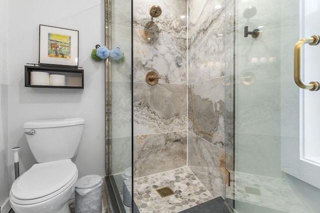 bathroom featuring an enclosed shower and toilet