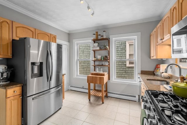 kitchen with a sink, appliances with stainless steel finishes, a baseboard heating unit, dark stone counters, and crown molding