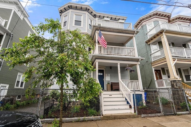 view of property with covered porch and fence