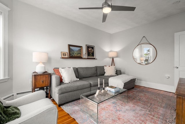 living room with ceiling fan, wood finished floors, a baseboard radiator, and baseboards