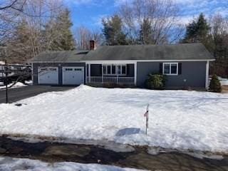 single story home with a garage and driveway