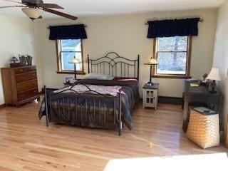 bedroom with a ceiling fan and wood finished floors